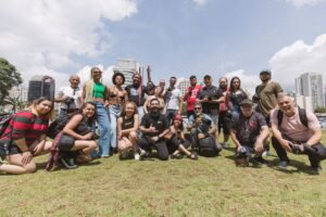 Group of diverse photographers posing outdoors on a sunny day.