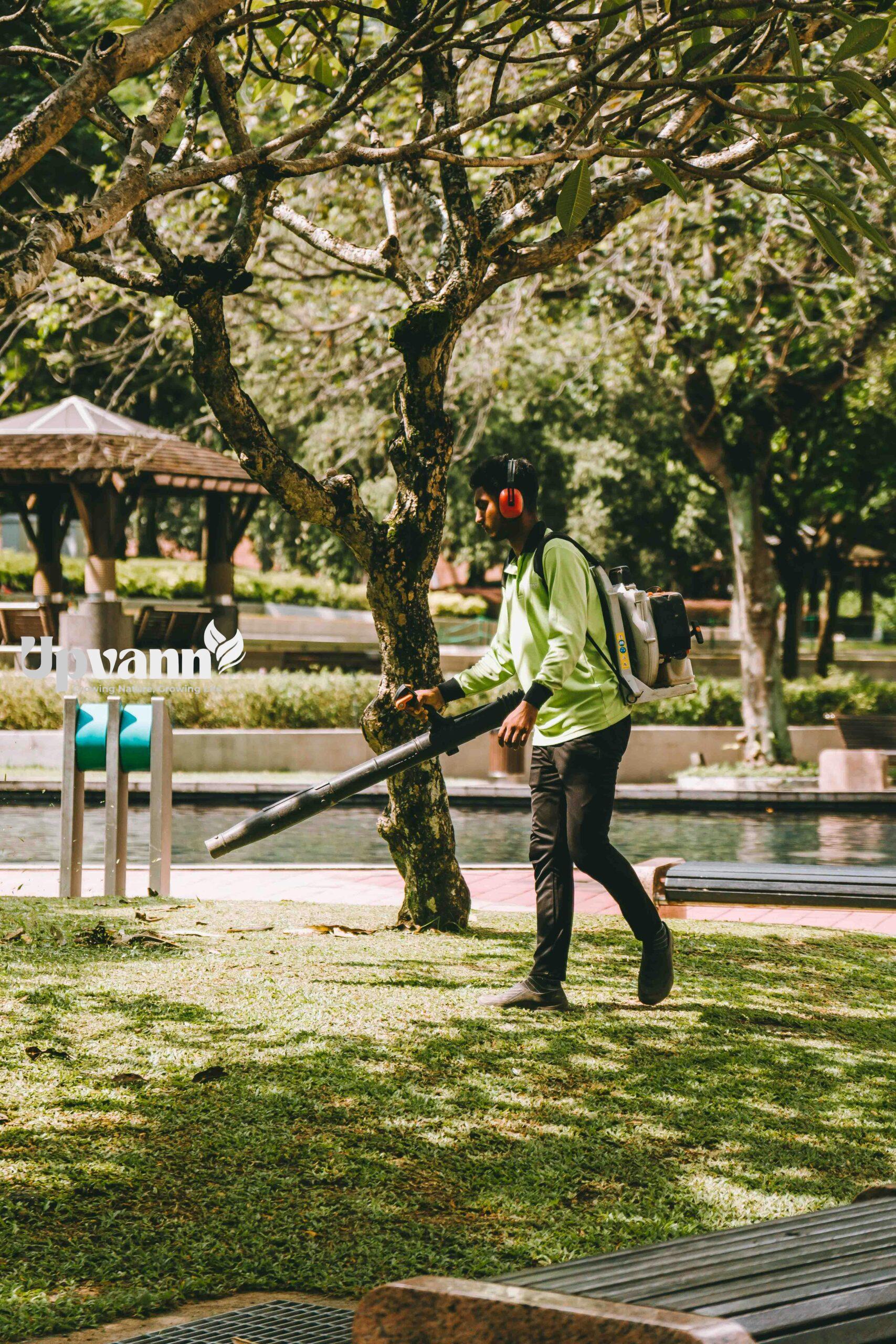 pexels photo 27135591 27135591 A man using a leaf blower in a vibrant Kuala Lumpur park, showcasing daily outdoor maintenance.